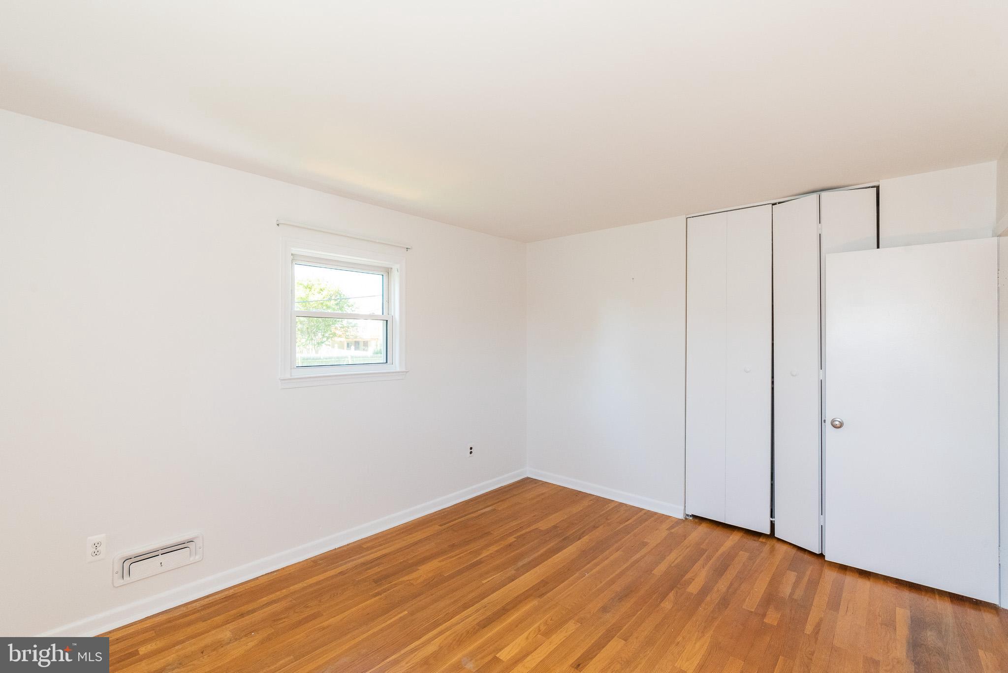 6129 Wheatland Road Baltimore, MD 21228 - Photo 17 of 48 a view of a room with wooden floor and white walls