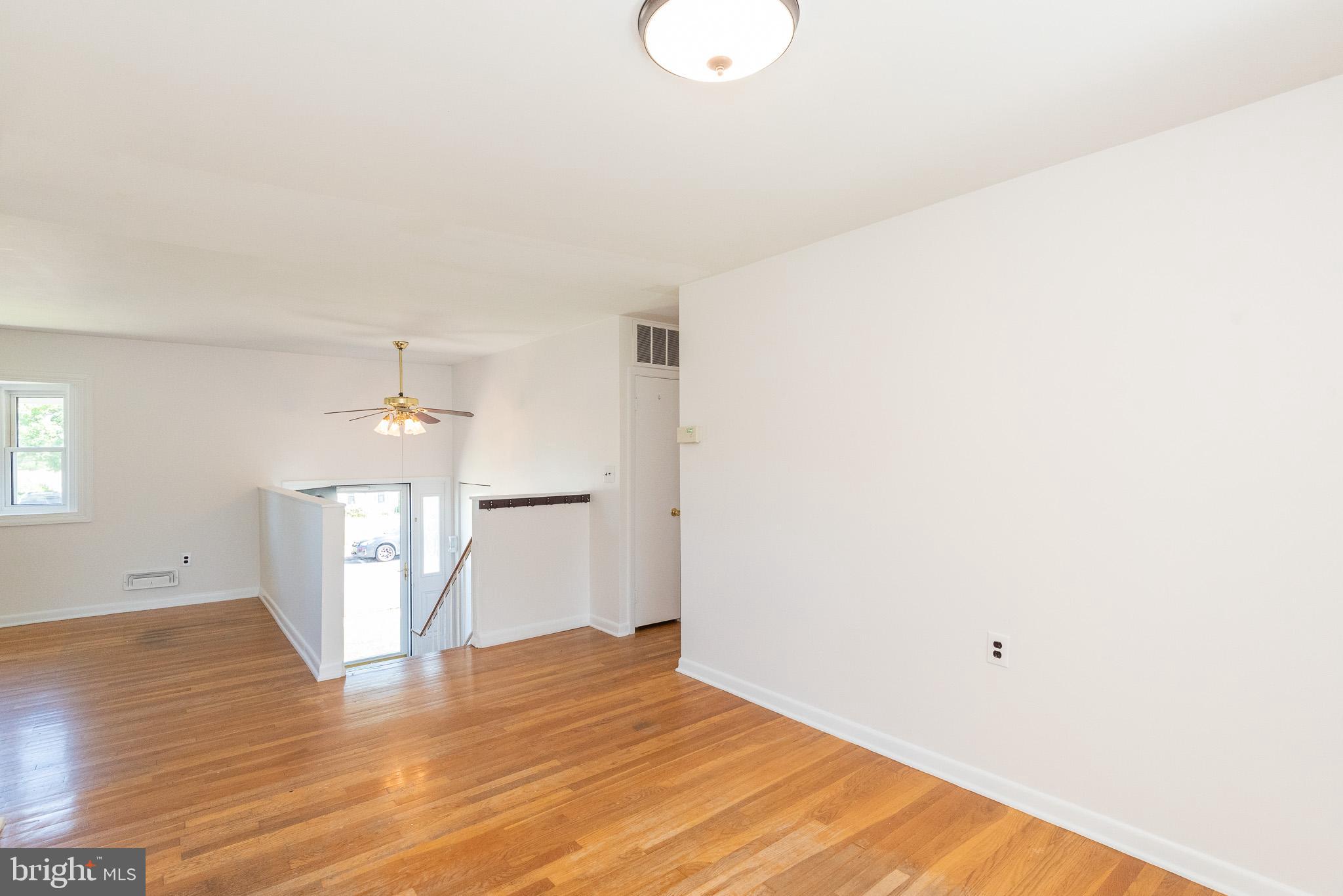 6129 Wheatland Road Baltimore, MD 21228 - Photo 29 of 48 a view of a room with wooden floor and white walls
