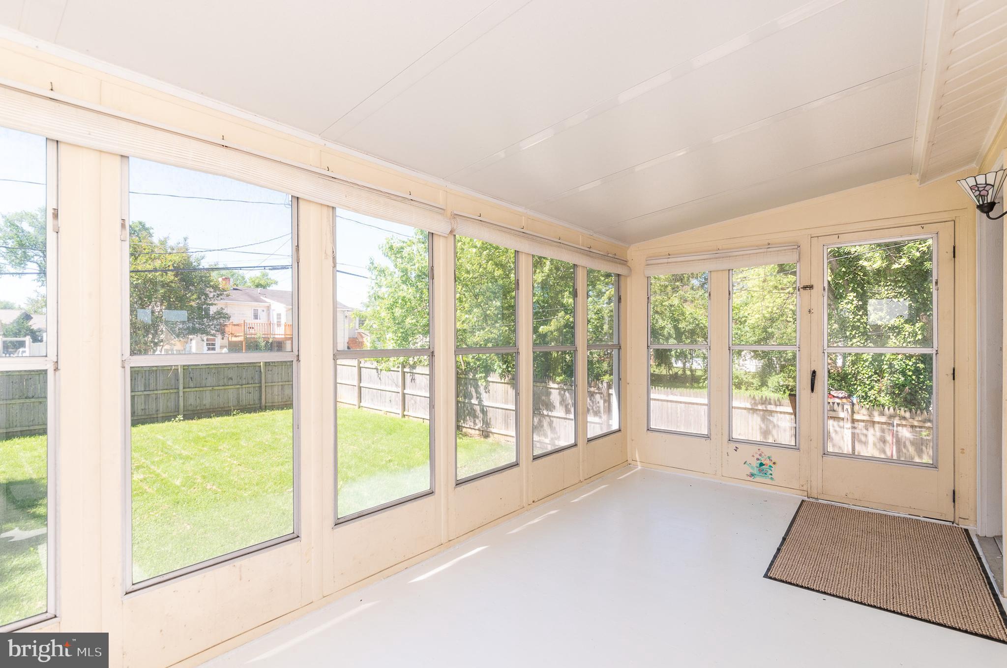 6129 Wheatland Road Baltimore, MD 21228 - Photo 33 of 48 a view of an empty room with wooden floor and windows