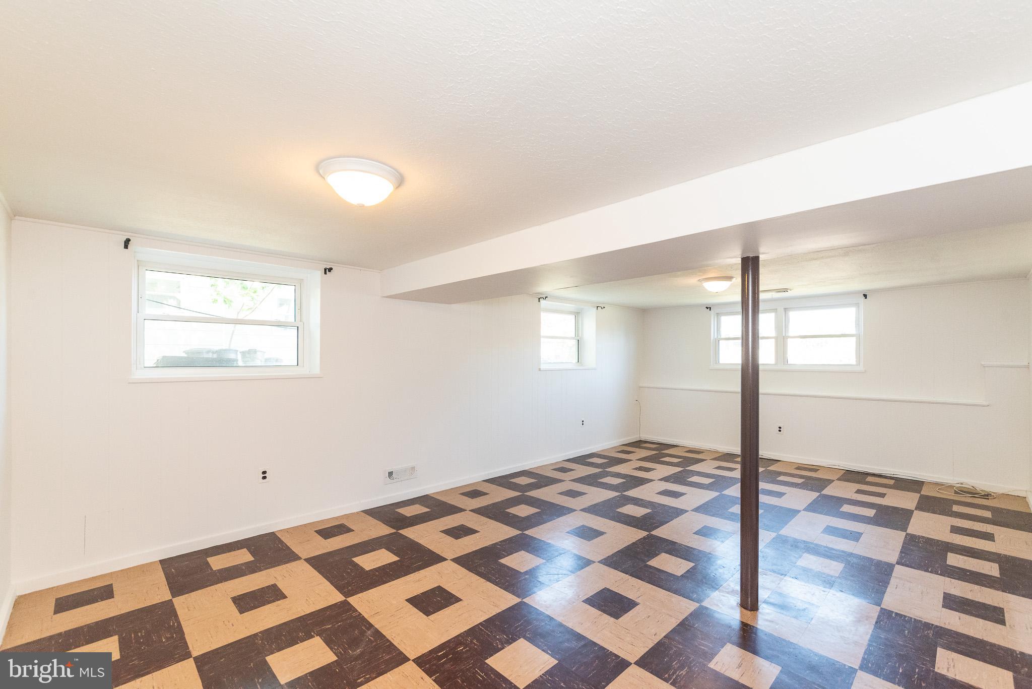 6129 Wheatland Road Baltimore, MD 21228 - Photo 36 of 48 a bedroom with a bed and a window