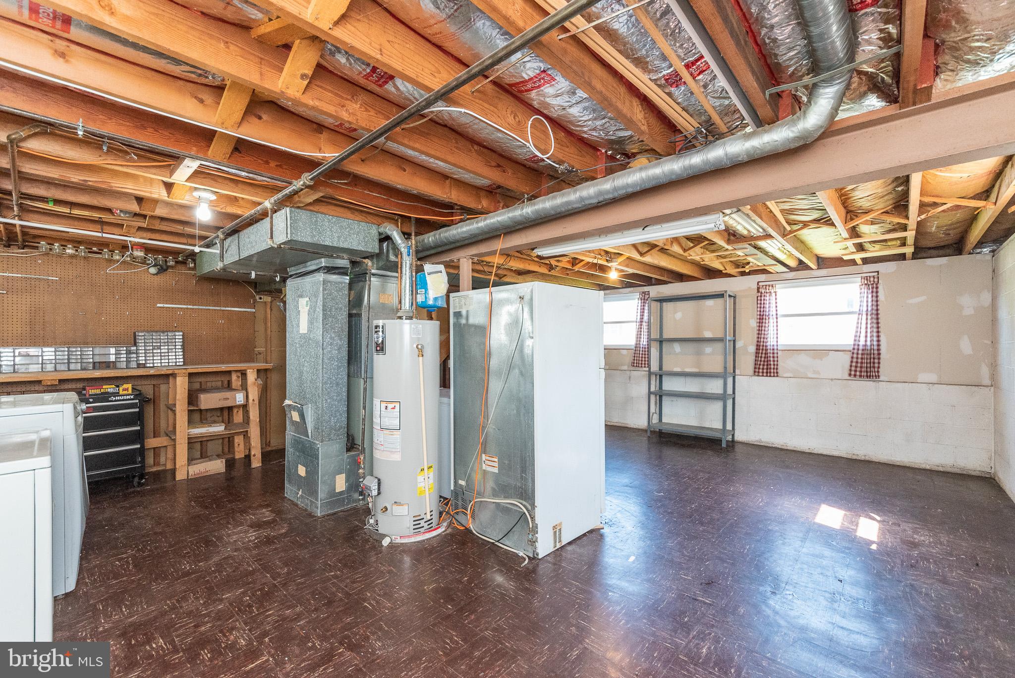 6129 Wheatland Road Baltimore, MD 21228 - Photo 44 of 48 a view of an empty room with wooden floor and staircase