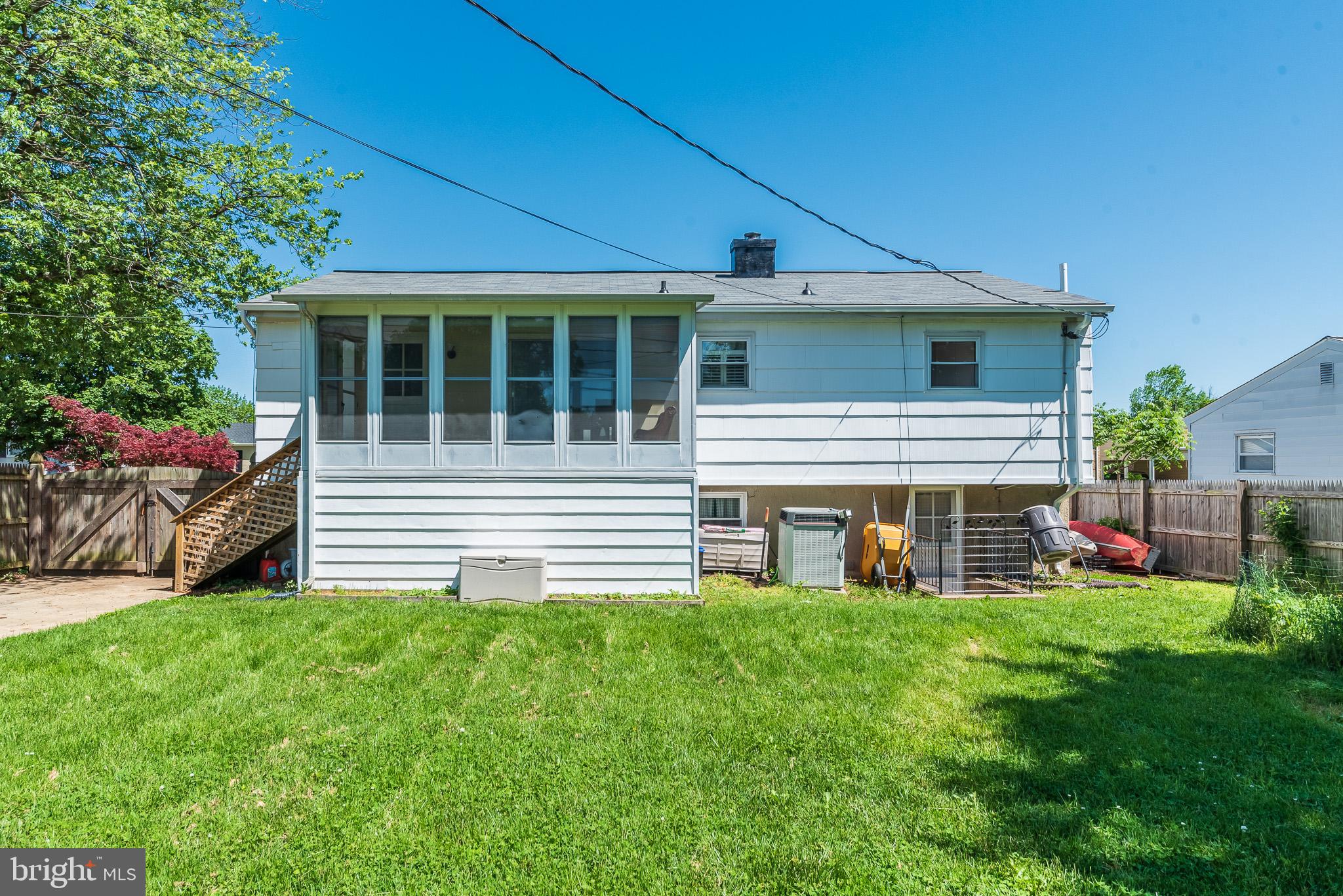 6129 Wheatland Road Baltimore, MD 21228 - Photo 46 of 48 a front view of a house with a garden and yard