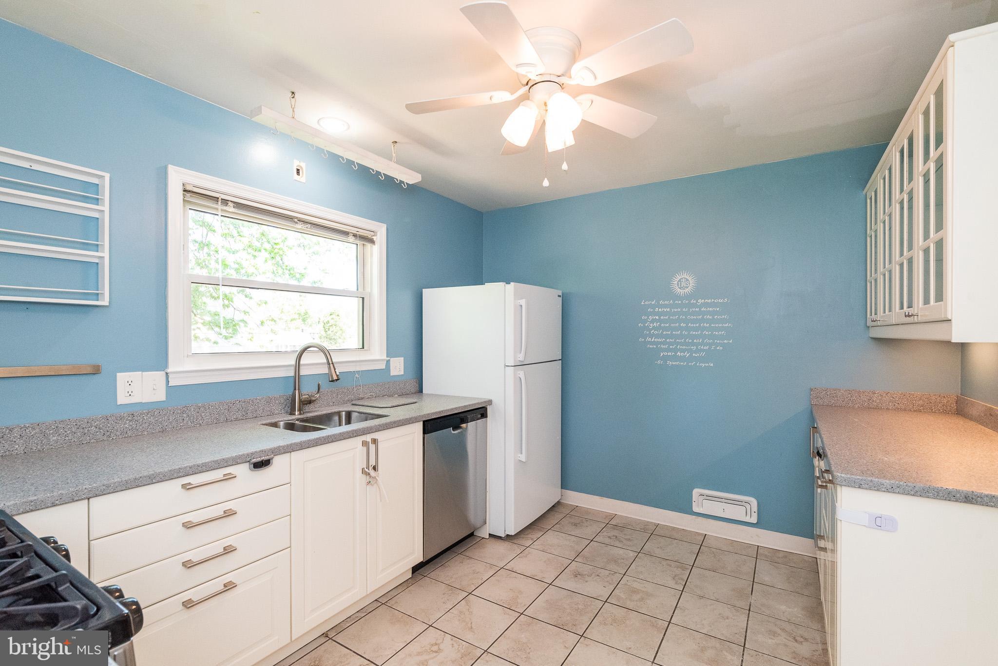 6129 Wheatland Road Baltimore, MD 21228 - Photo 9 of 48 a kitchen with a sink a window and cabinetry