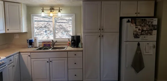 a kitchen with appliances cabinets and a counter top space