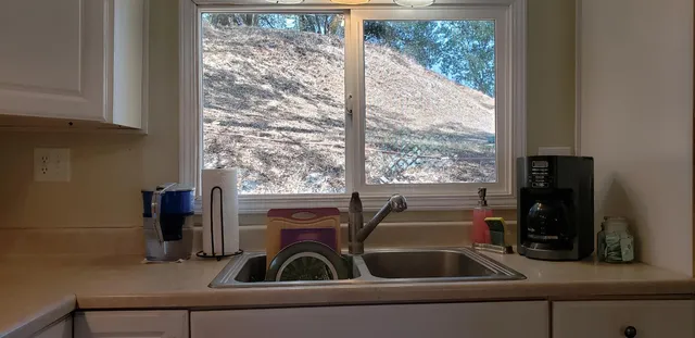 a view of living room with furniture and a floor to ceiling window