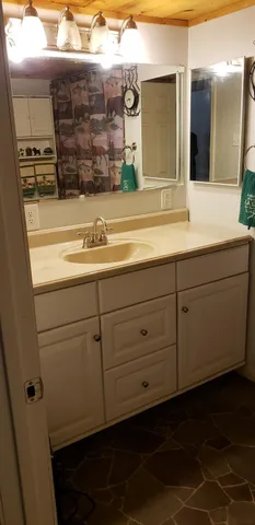 a bathroom with a sink and a mirror