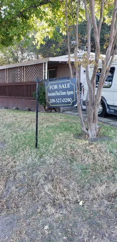 a view of a house with a yard and a fence