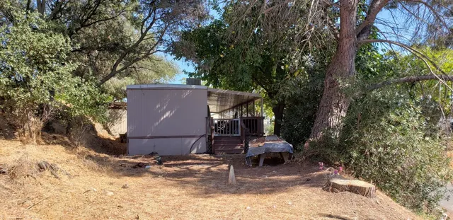 a view of a house with a yard and sitting area