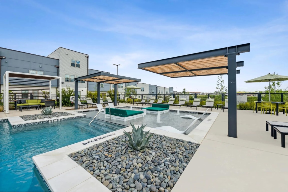 10350 Blue Bluff Road, Unit 10101 Austin, TX 78724 - Photo 25 of 27 a view of a patio with a table chairs and a yard