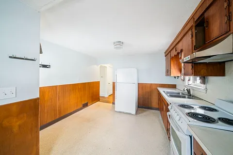 a kitchen with a stove and a refrigerator