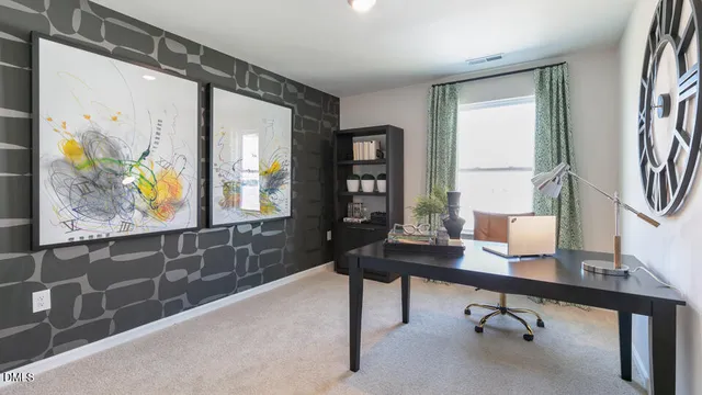 a view of a workspace with furniture and a window