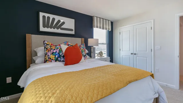 a bed sitting in a bedroom next to a window