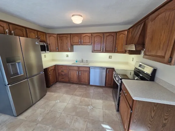 a kitchen with a sink appliances and cabinets
