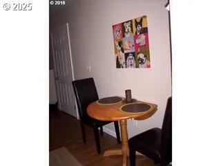 a dining room with furniture and wooden floor
