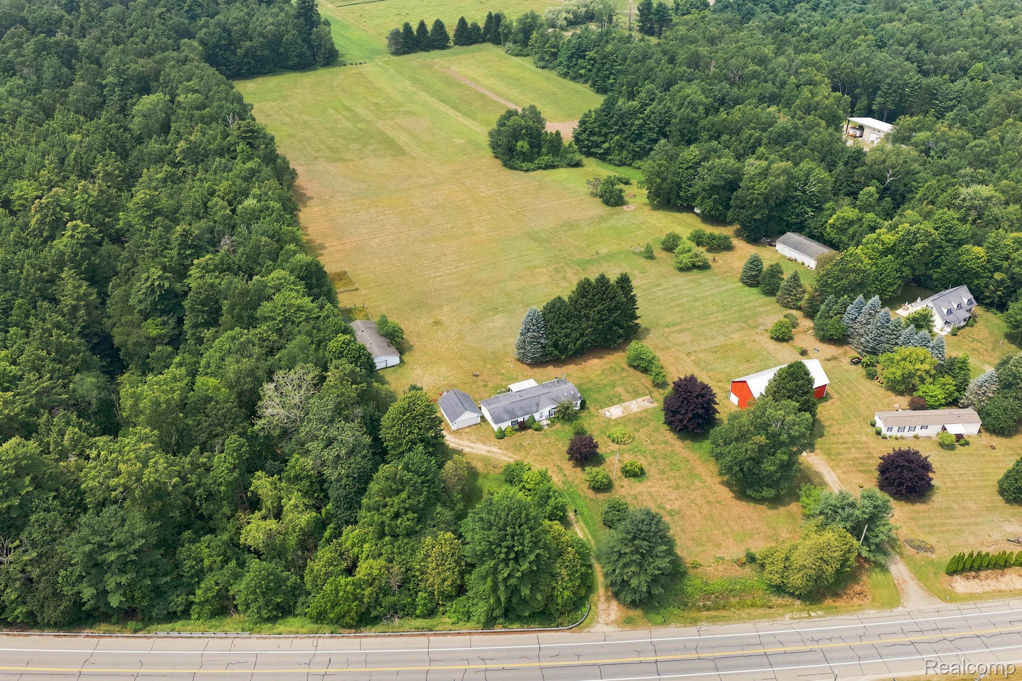 2390 Lakeshore Road Applegate, MI 48401 - Photo 92 of 97 Scenic rural property featuring multiple residences set on expansive grounds with mature tree-lined perimeter, open pastureland, and direct highway access