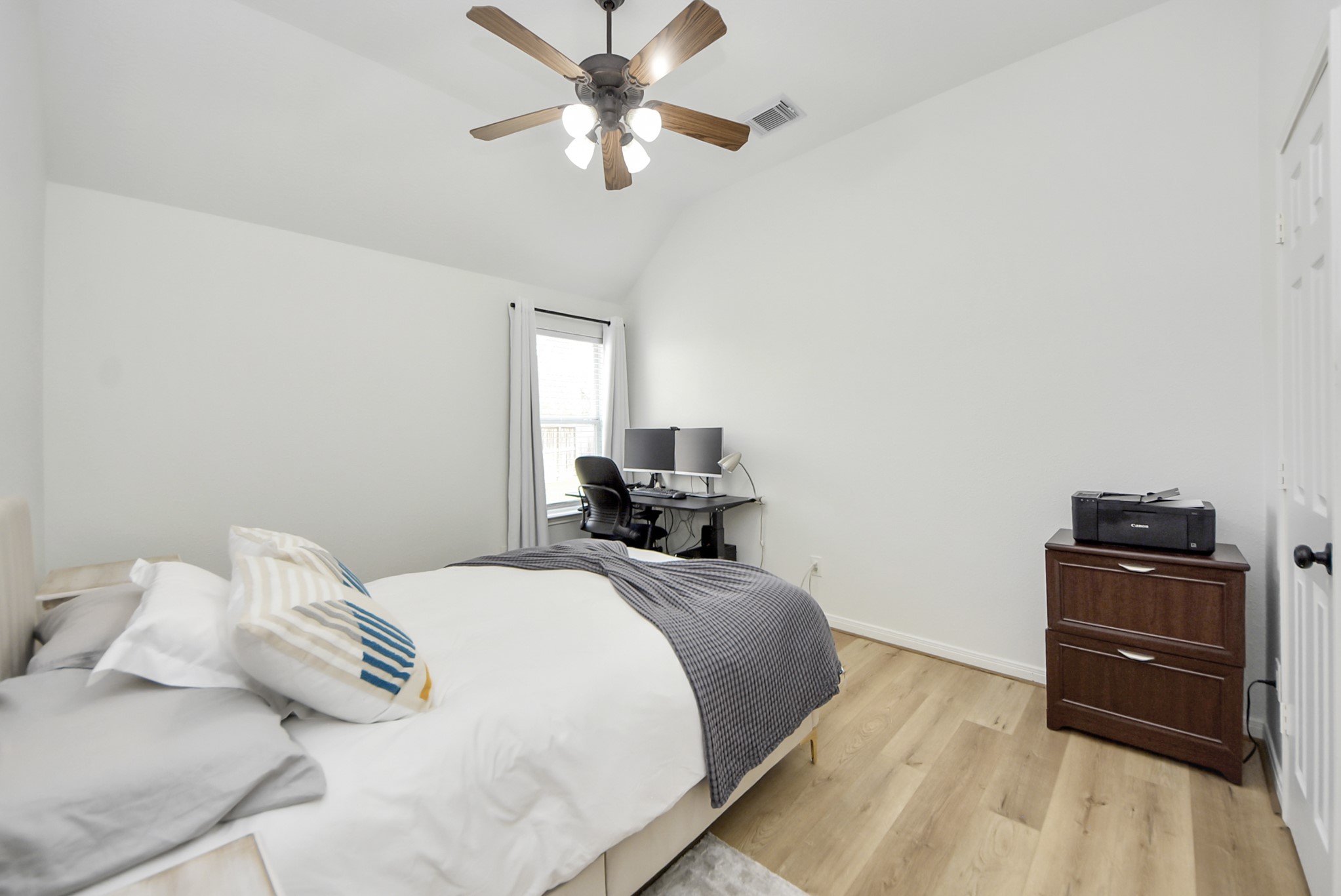 1910 Fox Path Court Katy, TX 77494 - Photo 20 of 29 a bedroom with a bed and a chandelier