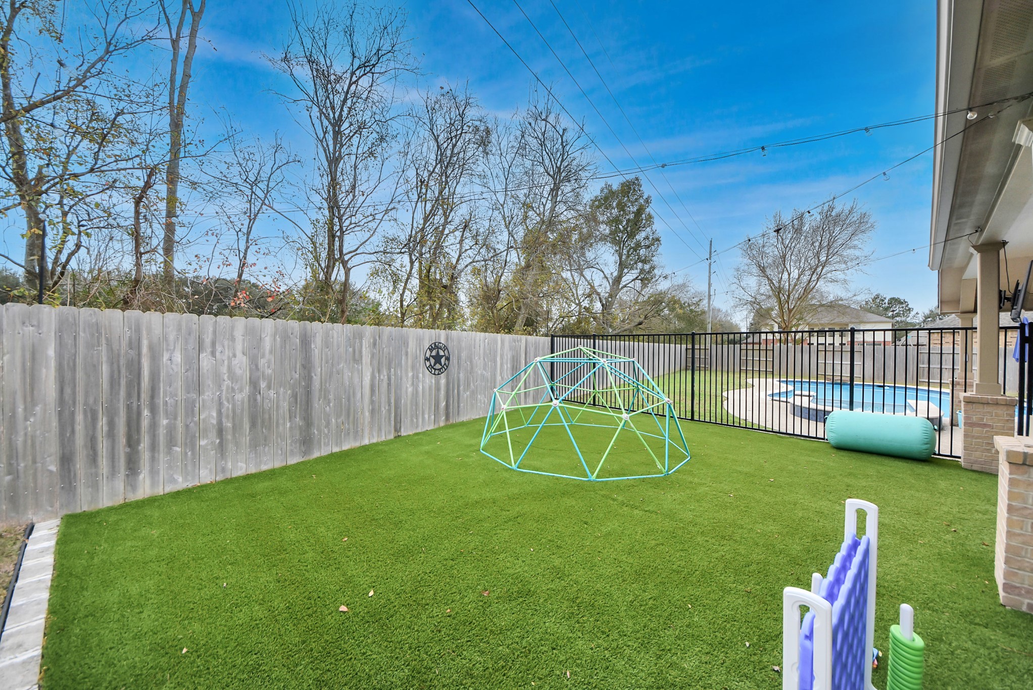 1910 Fox Path Court Katy, TX 77494 - Photo 27 of 29 a view of a backyard with a slide trees and wooden fence
