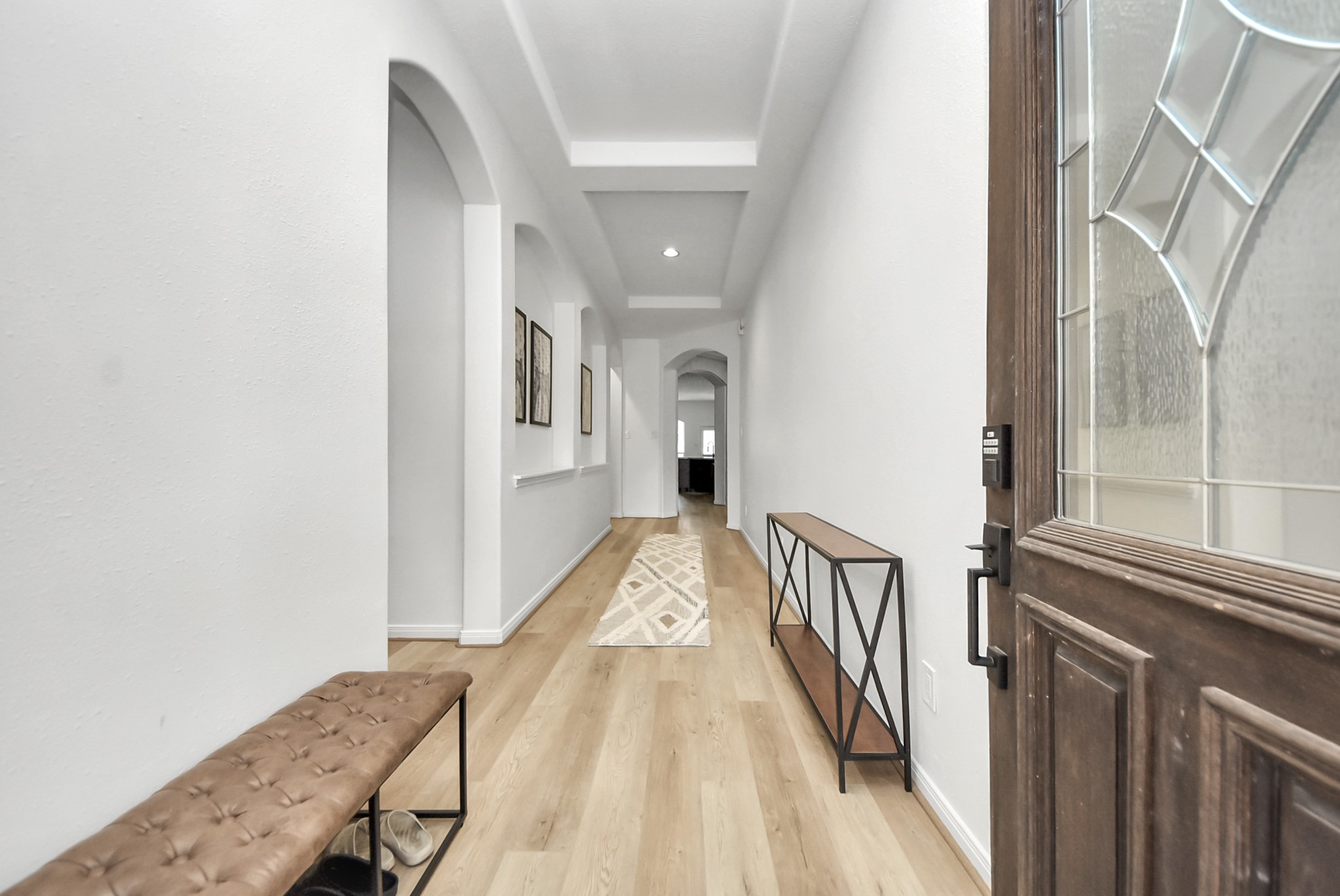1910 Fox Path Court Katy, TX 77494 - Photo 3 of 29 a view of a hallway with wooden floor and staircase