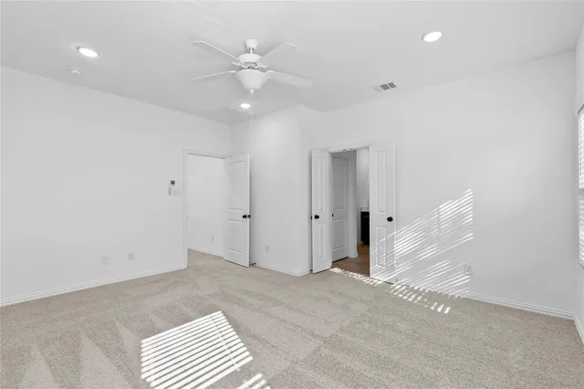 a view of an empty room with a fan