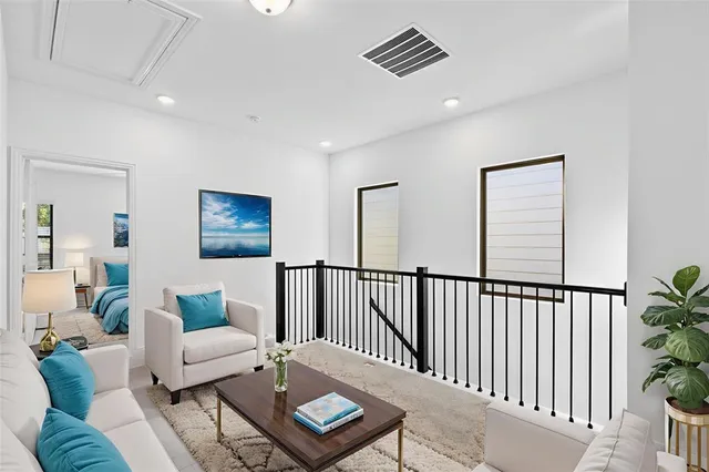a living room with furniture and a potted plant