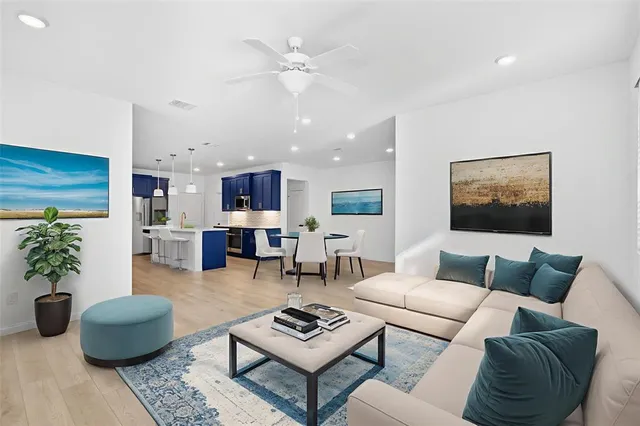 a living room with furniture and wooden floor