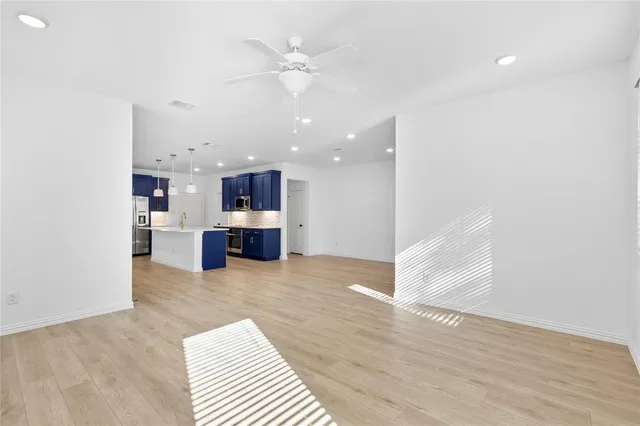 a view of kitchen and hall with wooden floor