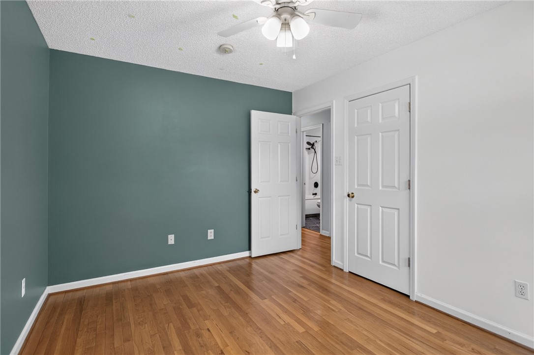 113 Greenfield Avenue Pendleton, SC 29670 - Photo 19 of 40 Hardwood floors and a ceiling fan create a comfortable and inviting atmosphere in this versatile room.