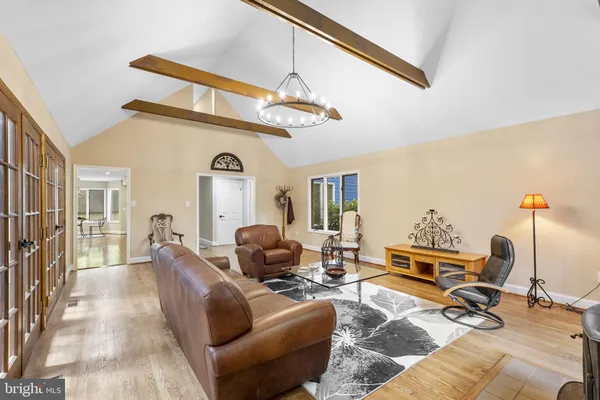 a view of a livingroom with furniture wooden floor and windows
