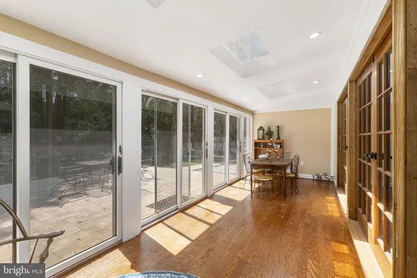 a bed sitting in a spacious bedroom next to a window