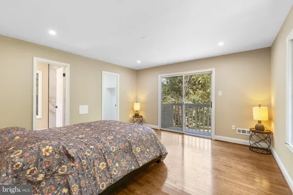 a view of a room with wooden floor and a rug