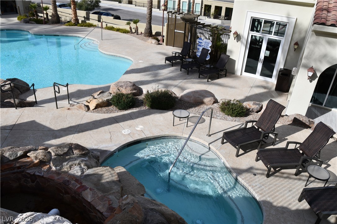 2555 Hampton Road, Unit 7109 Henderson, NV 89052 - Photo 8 of 34 A refreshing outdoor space features a sparkling pool, an inviting spa, and comfortable lounging areas.