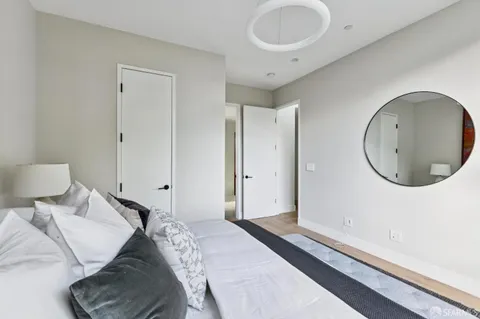 a bedroom with a bed and a mirror
