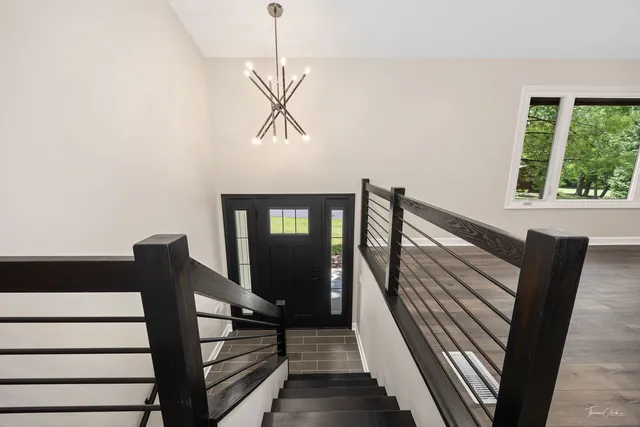 an empty room with wooden floor and fireplace