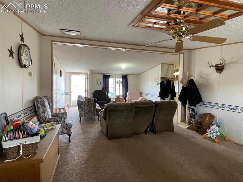 1526 R Path Cotopaxi, CO 81223 - Photo 16 of 30 a living room with furniture and a chandelier