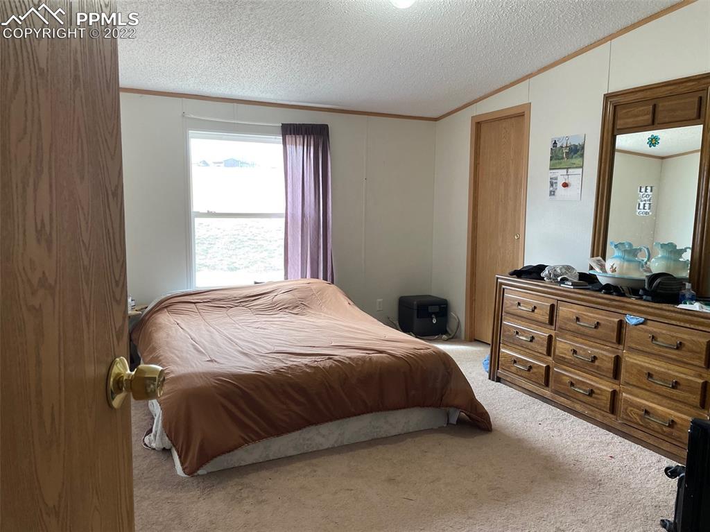 1526 R Path Cotopaxi, CO 81223 - Photo 26 of 30 a bedroom with a bed and dresser
