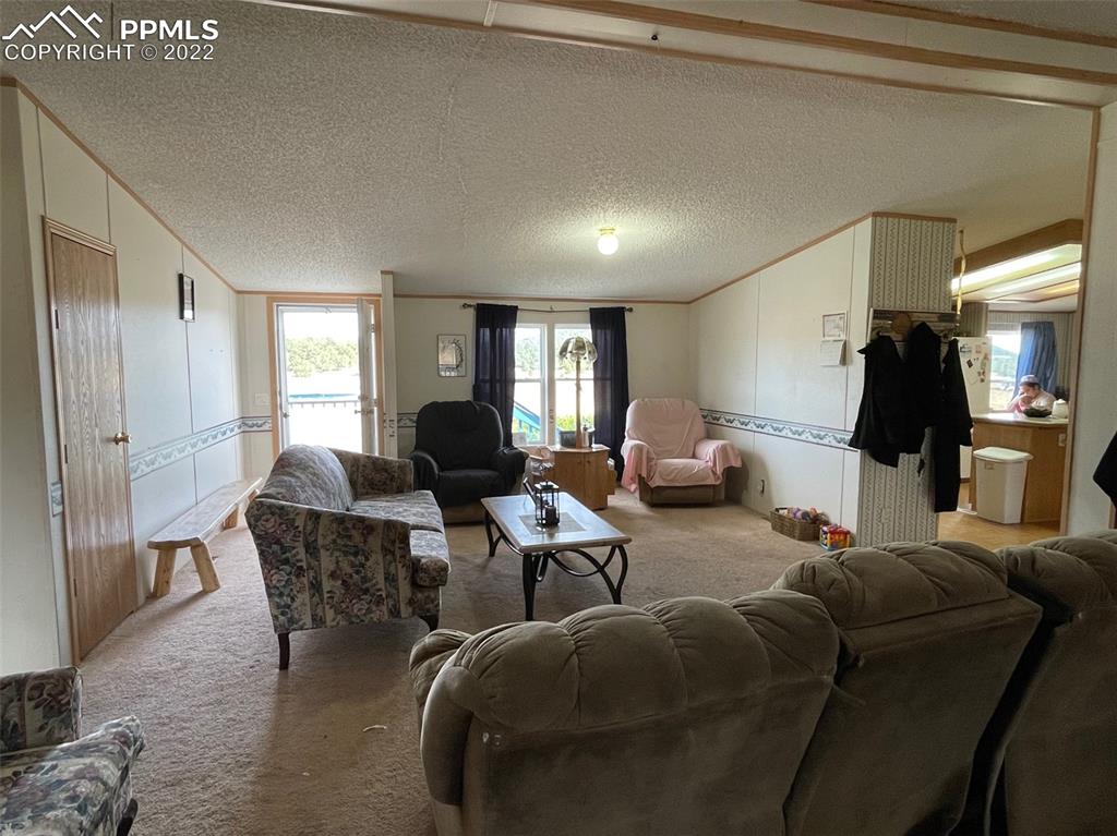 1526 R Path Cotopaxi, CO 81223 - Photo 7 of 30 a living room with furniture a large window and a chandelier