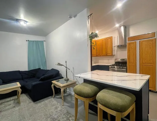 a kitchen with a dining table chairs and white appliances
