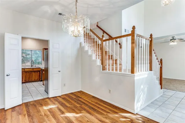 a view of a bedroom with wooden floor and windows