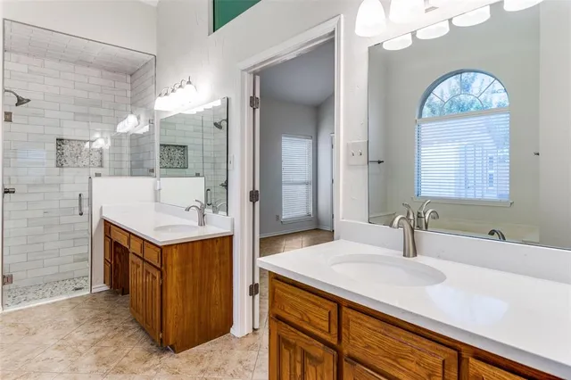 a bathroom with a sink double vanity and a mirror