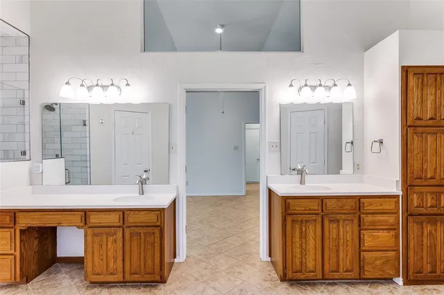 a bathroom with a double vanity sink and a mirror