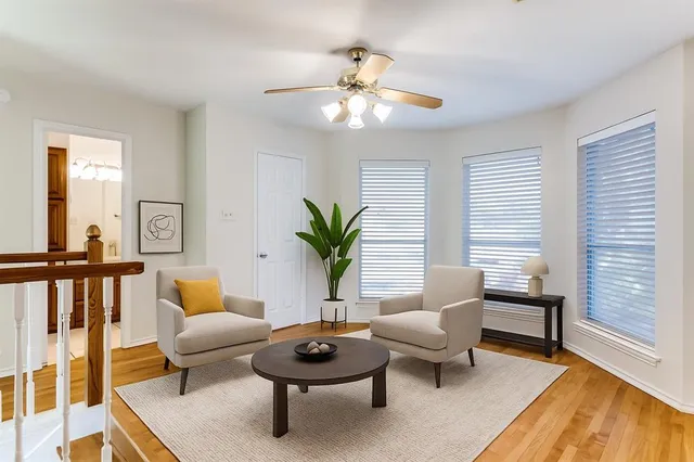 a living room with furniture and a potted plant