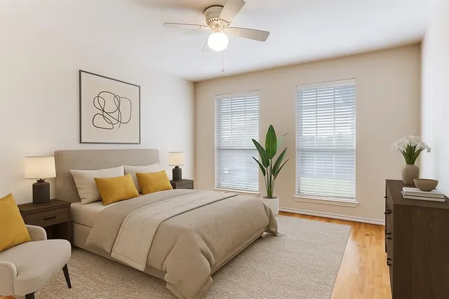 a bedroom with a bed and a potted plant