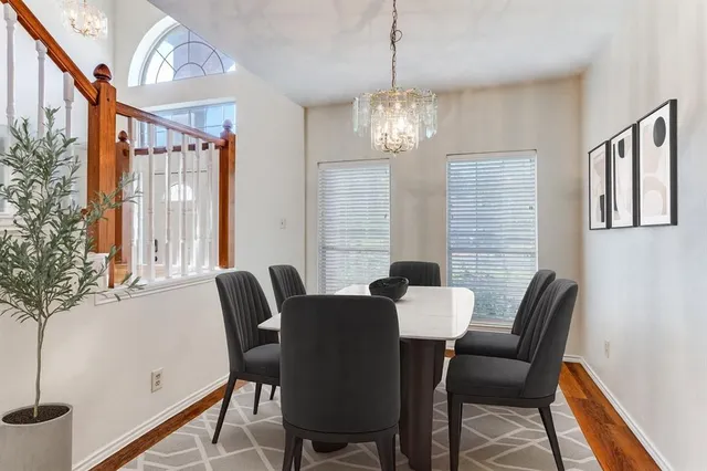 a view of a dining room with furniture wooden floor and chandelier