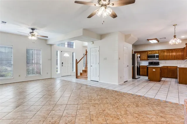 a view of a kitchen with a sink and a refrigerator wooden cabinets