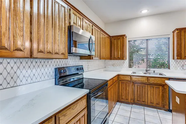 a kitchen that has a sink and a stove in it