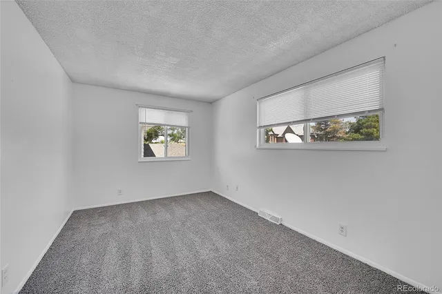 a view of an empty room and closet area