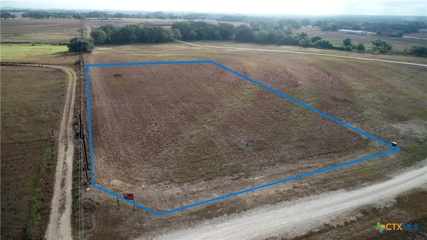 a view of a field and trees