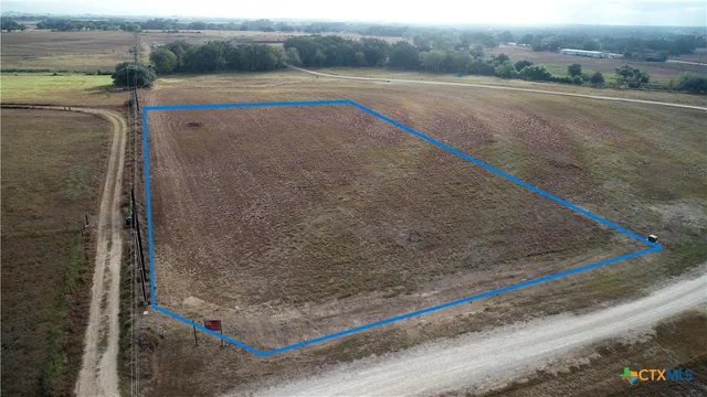 a view of a field and trees