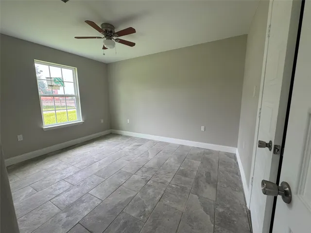 a view of a livingroom with a ceiling fan and window