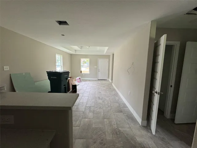 a living room with furniture and a entryway